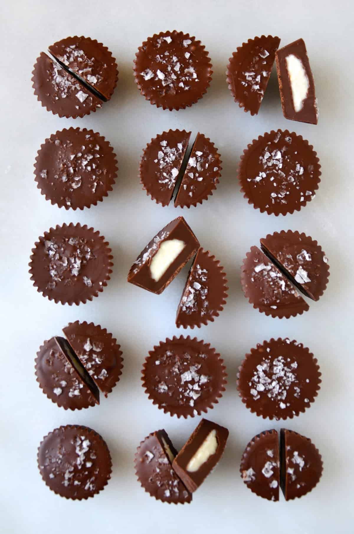 Three rows of chocolate cheesecake cups topped with large-flake sea salt.
