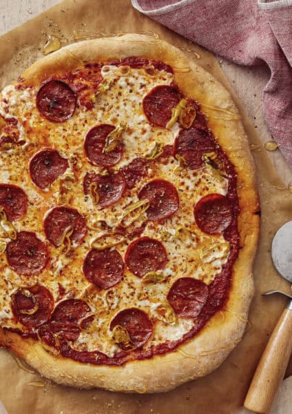 Pepperoni pizza with banana peppers drizzled with hot honey.