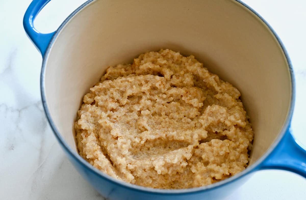 Creamy quinoa made with coconut milk in a light blue pot.