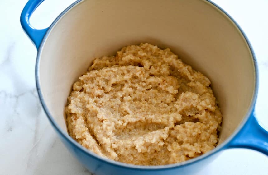 A sauce pot containing cooked quinoa