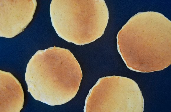A griddle with ricotta pancakes on top