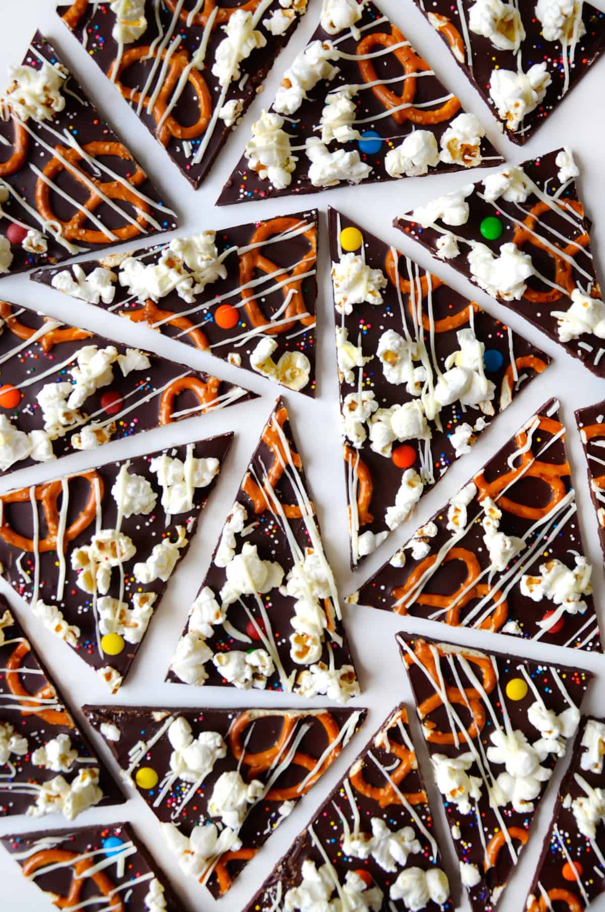 Chocolate bark candy topped with popcorn, pretzels, M&Ms and drizzled with white chocolate.