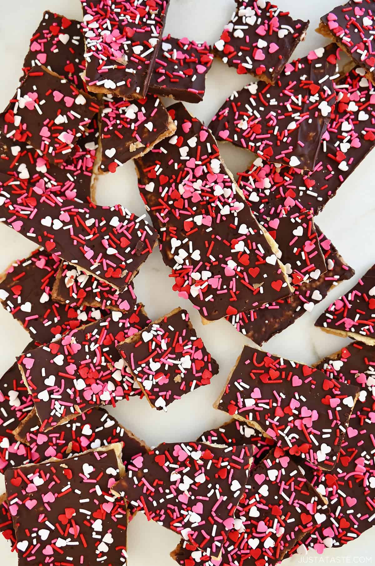 Valentine's Saltine Cracker toffee with heart-shaped sprinkles in pink, red and white.