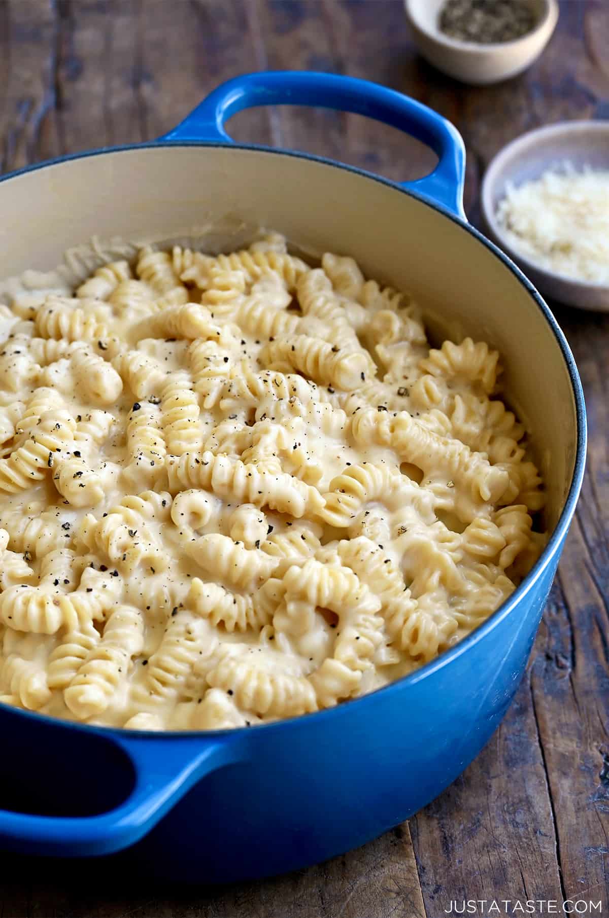 A large blue stockpot containing macaroni and cheese.