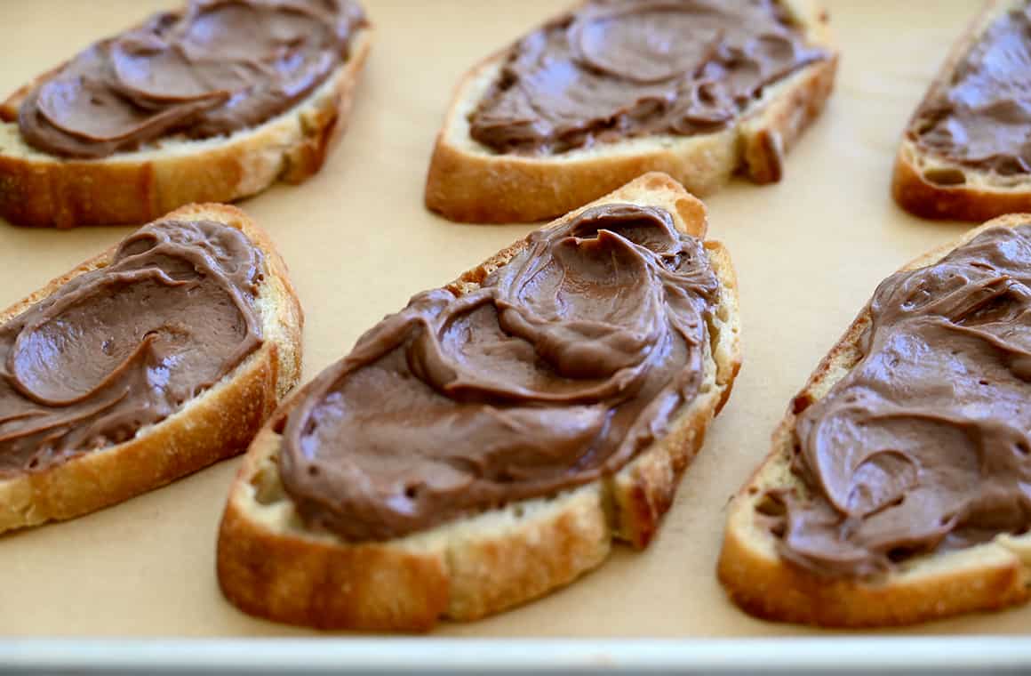 Slices of toasted baguette topped with whipped Nutella-cream cheese