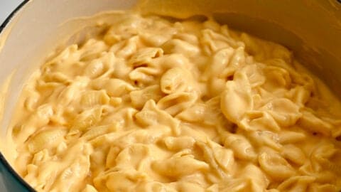 Creamy stovetop mac and cheese in a light blue stockpot.