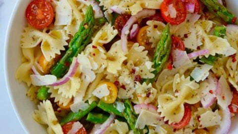 Large white bowl containing Asparagus Pasta Salad with Italian Dressing