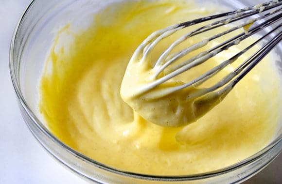 Whisk and bowl with vanilla bean pastry cream