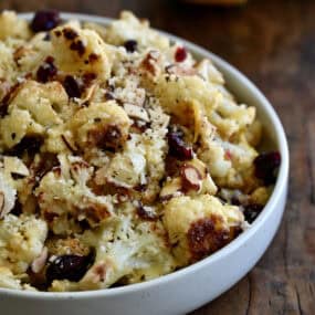 Roasted cauliflower salad with dried cranberries, toasted almonds and Parmesan cheese, all tossed in a sweet and tangy lemon dressing.