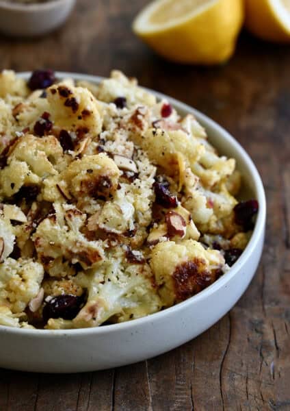 Roasted cauliflower salad with dried cranberries, toasted almonds and Parmesan cheese, all tossed in a sweet and tangy lemon dressing.