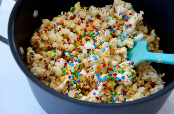 Large stock pot with spatula stirring marshmallow treats