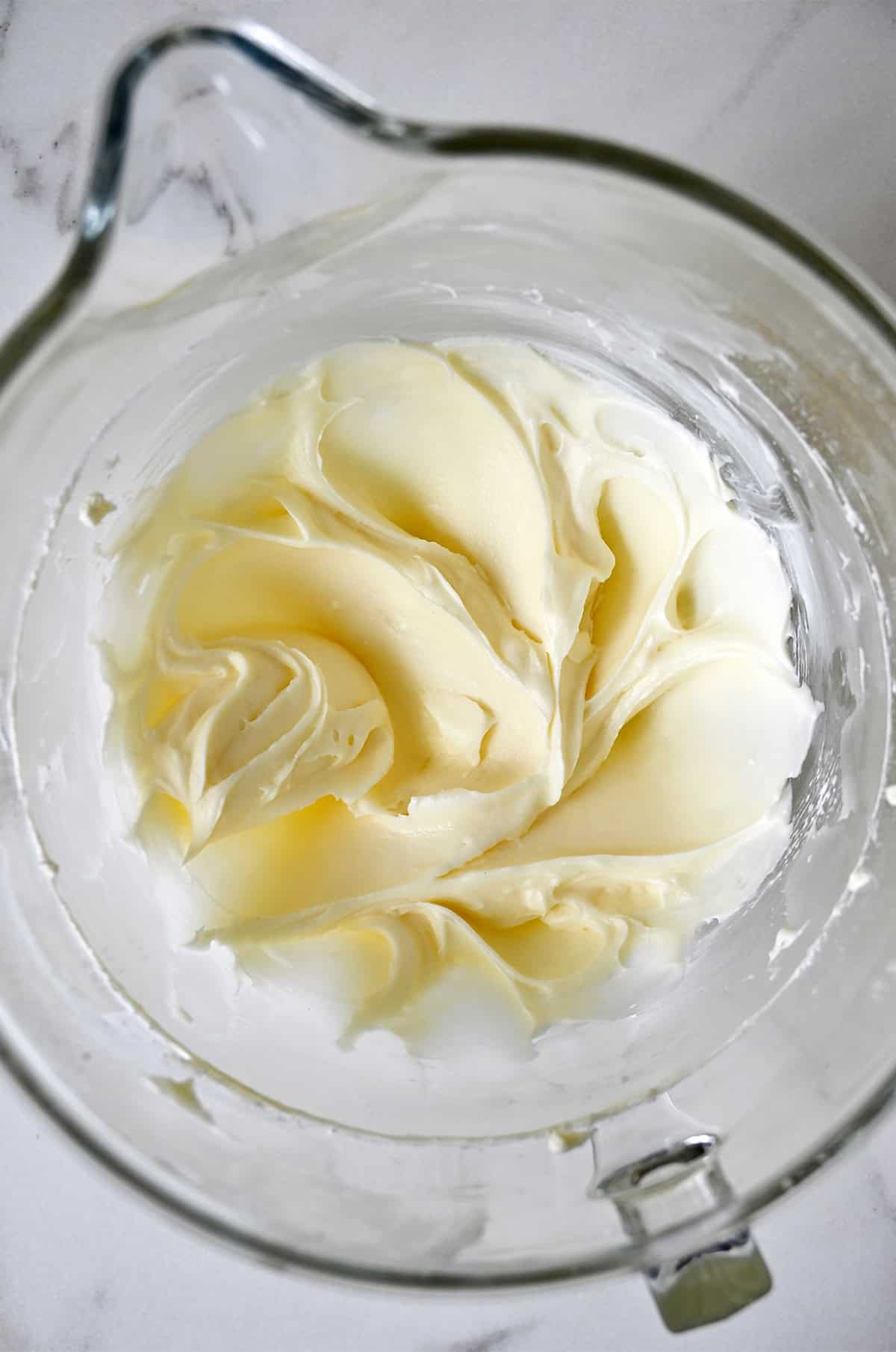 Cream cheese frosting in a stand mixer bowl.