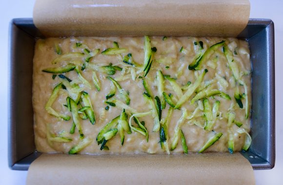 Parchment paper-lined loaf pan containing batter 