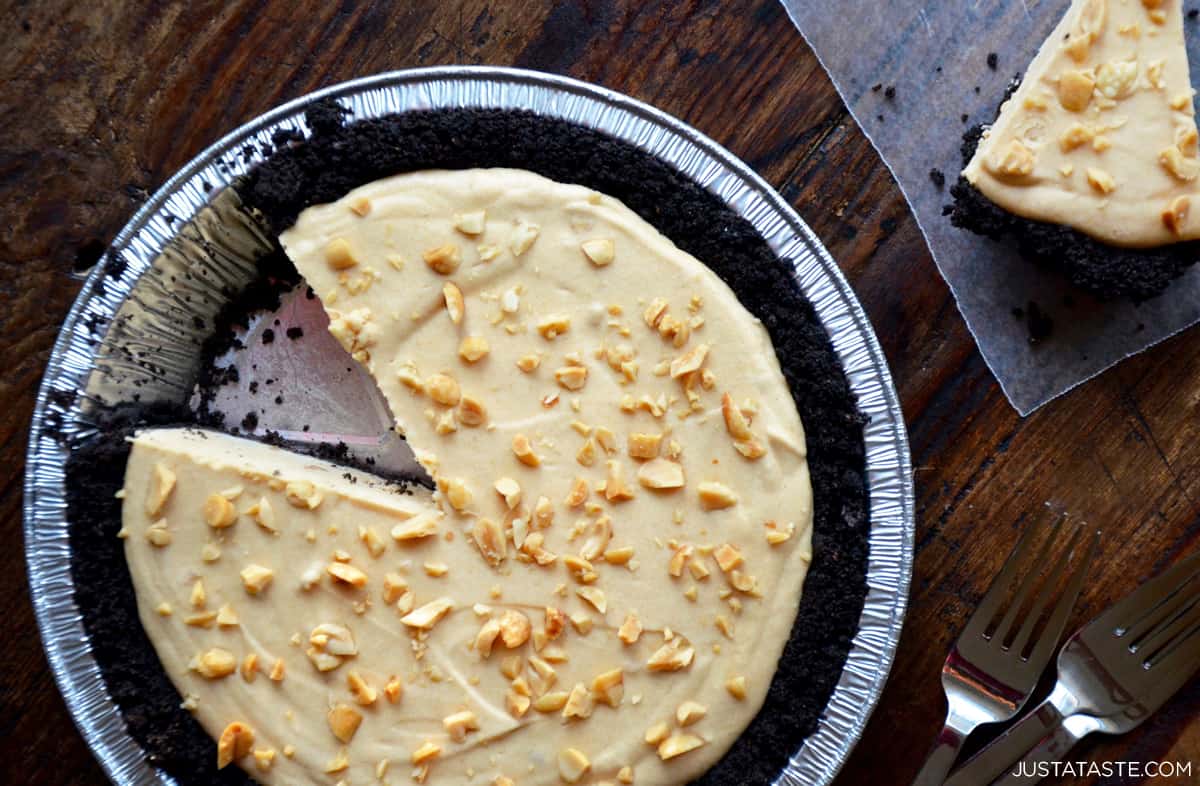 A top-down view of a frozen peanut butter and banana pie with a Oreo cookie crust.