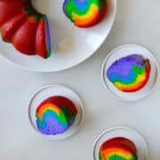 Top-down view of an easy rainbow bundt cake with three slices on small serving plates