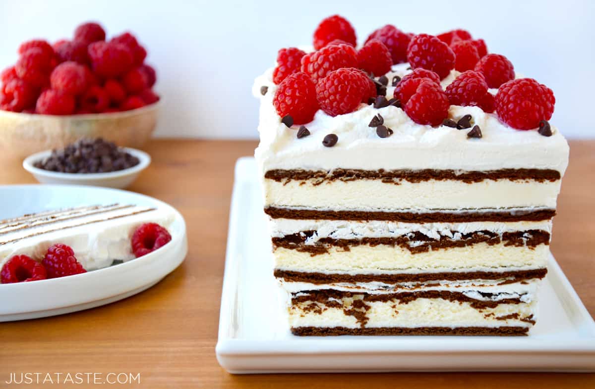 An ice cream sandwich cake topped with whipped cream, fresh raspberries and mini chocolate chips.