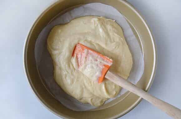 Coffee cake batter in a round cake pan.