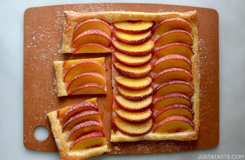 A top-down view of the best 5-ingredient peach tart on a wooden cutting board.