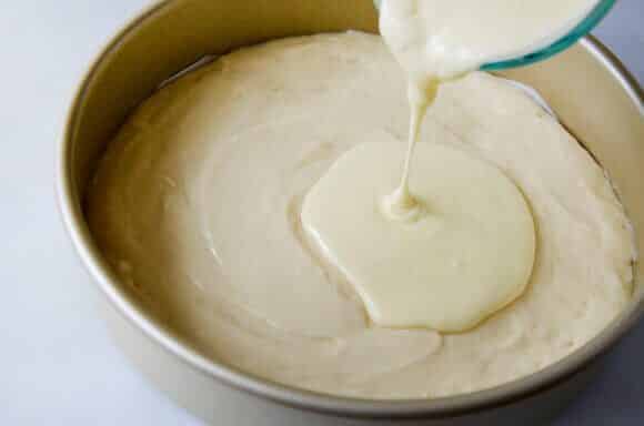 Cheesecake filling atop coffee cake batter in a round pan.