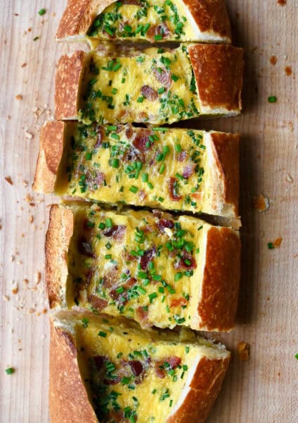 Cheesy baked egg boat with bacon garnished with fresh chopped chives.