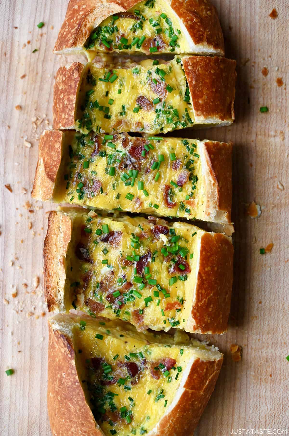 Cheesy baked egg boat with bacon garnished with fresh chopped chives.
