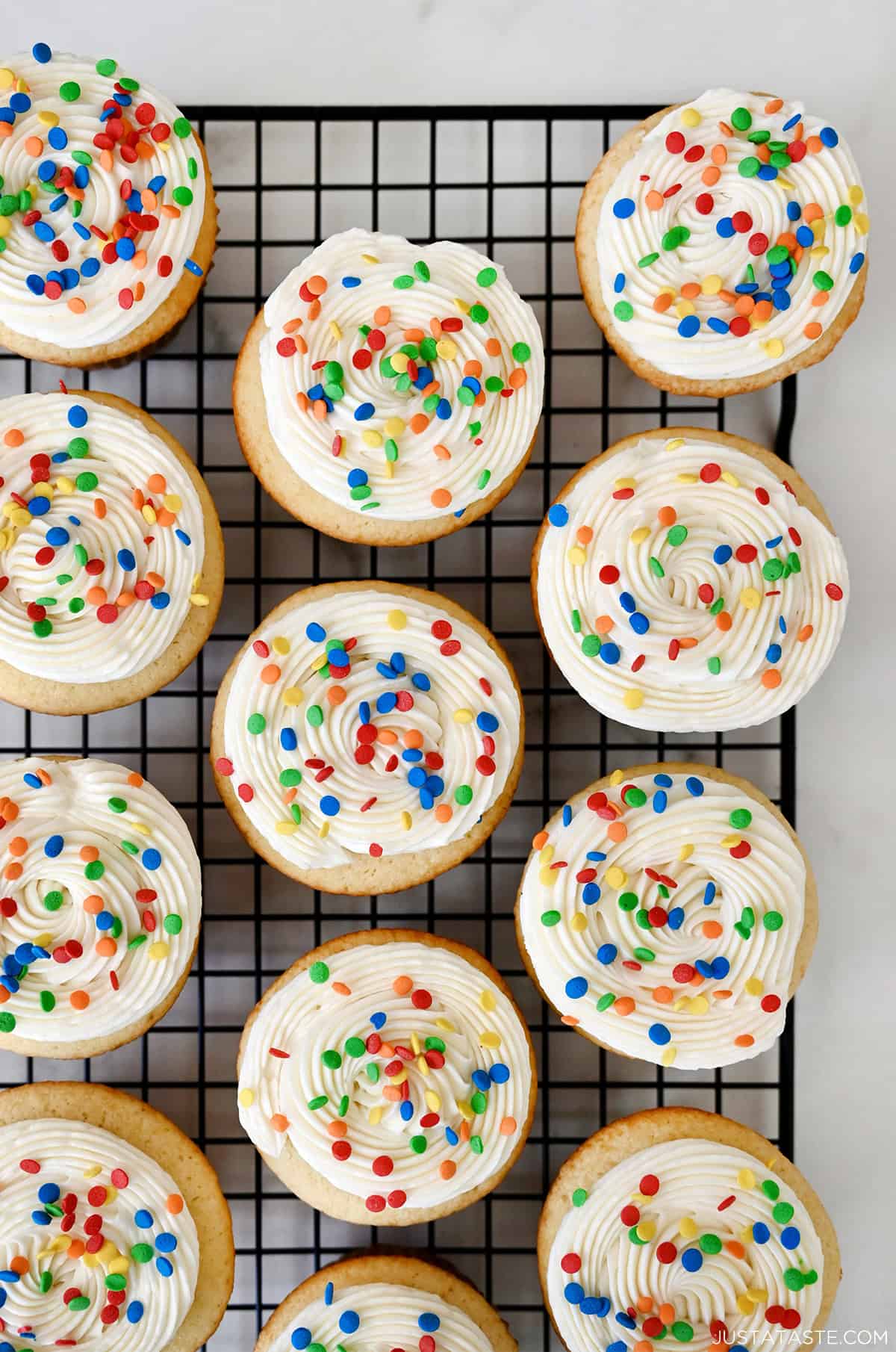 Vanilla buttercream frosting on top of vanilla cupcakes.