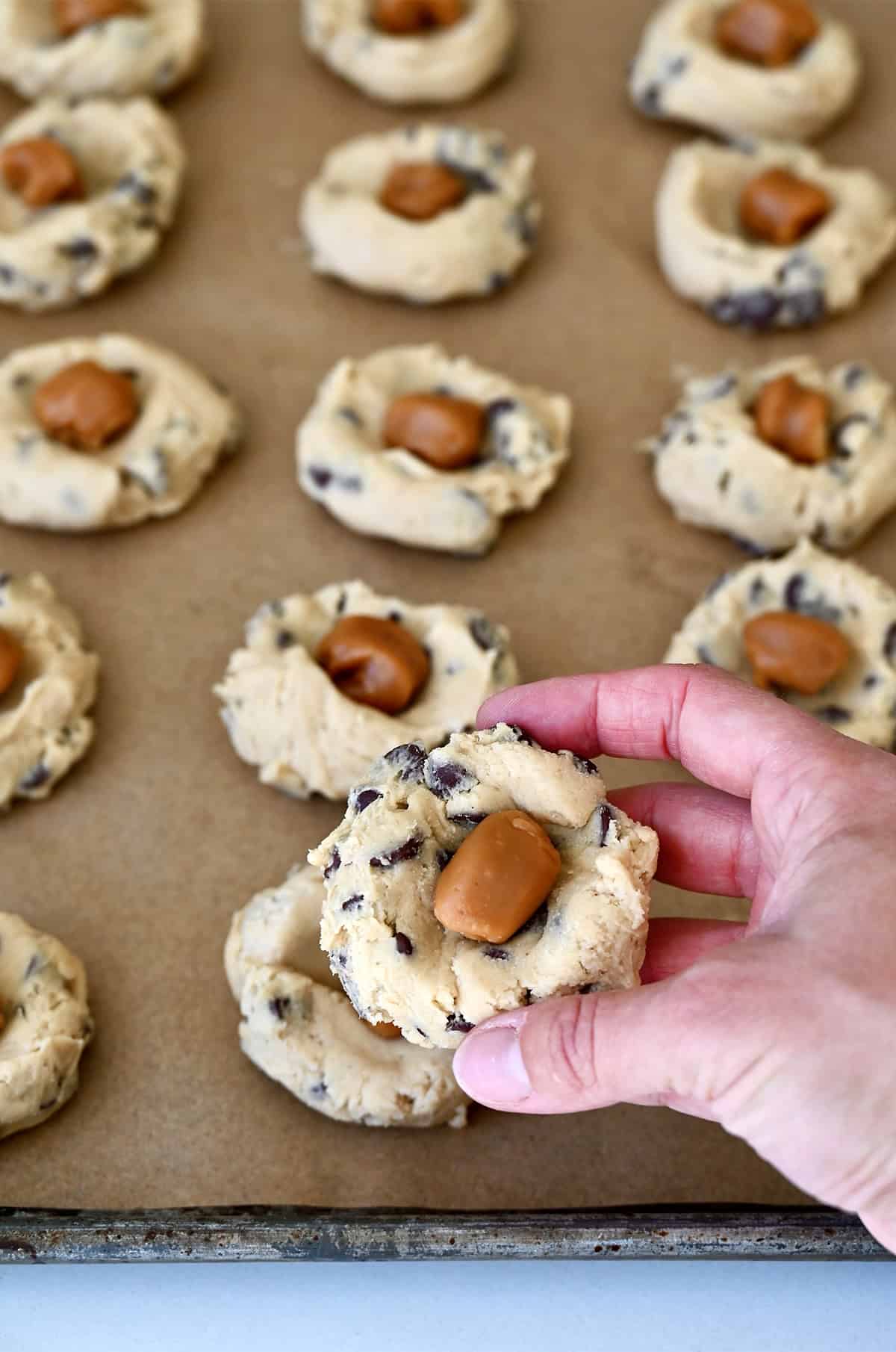 A soft caramel in the center of chocolate chip cookie dough.
