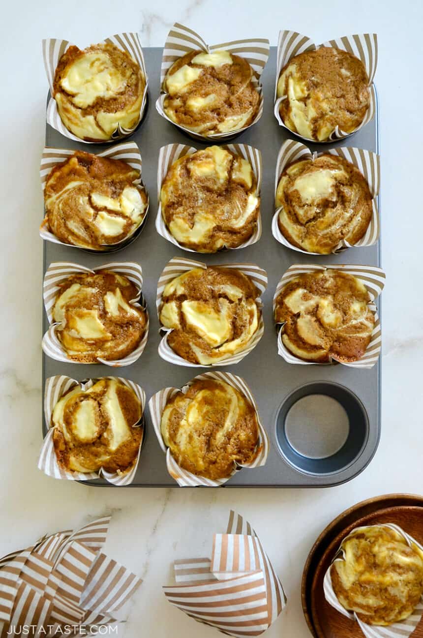 A muffin tin containing Cream Cheese Pumpkin Muffins