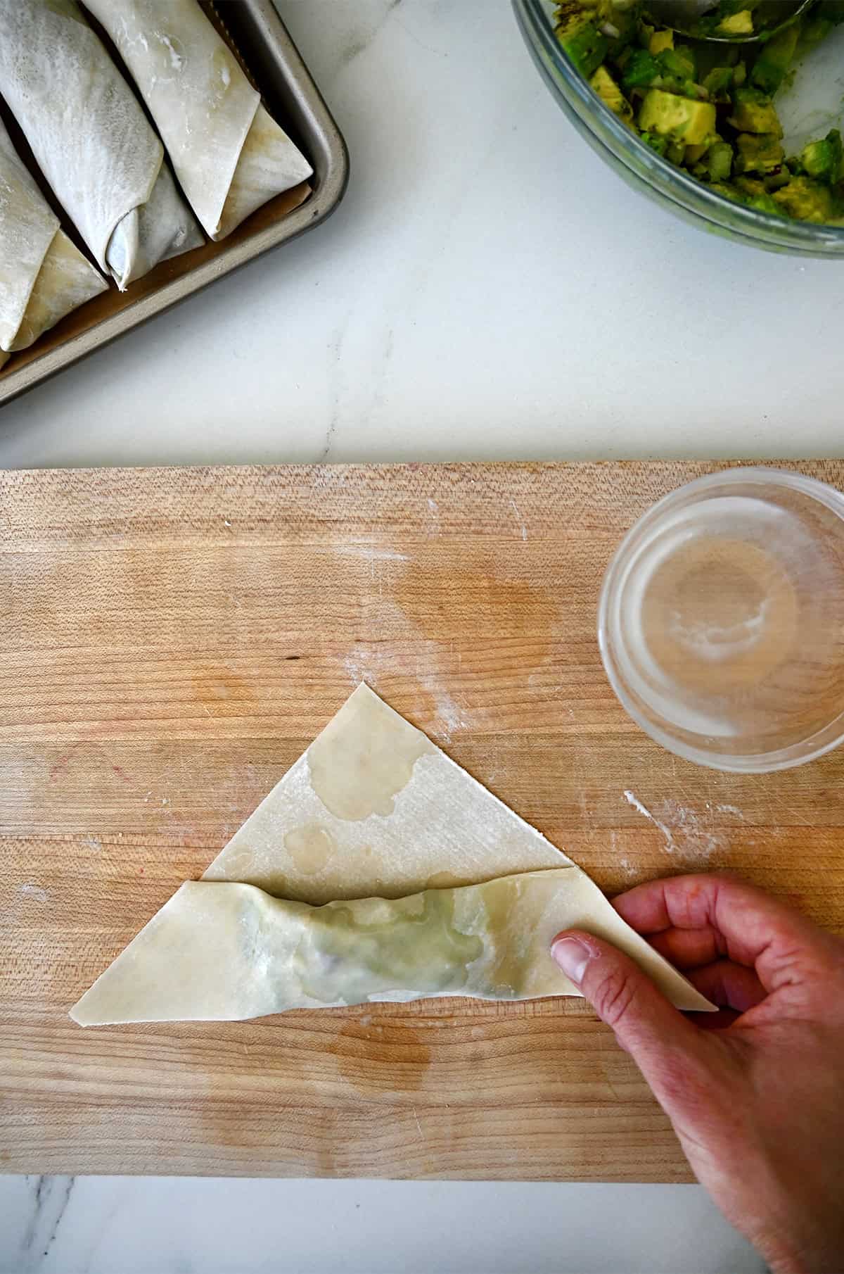 The second fold when making egg rolls just before folding in the corners.