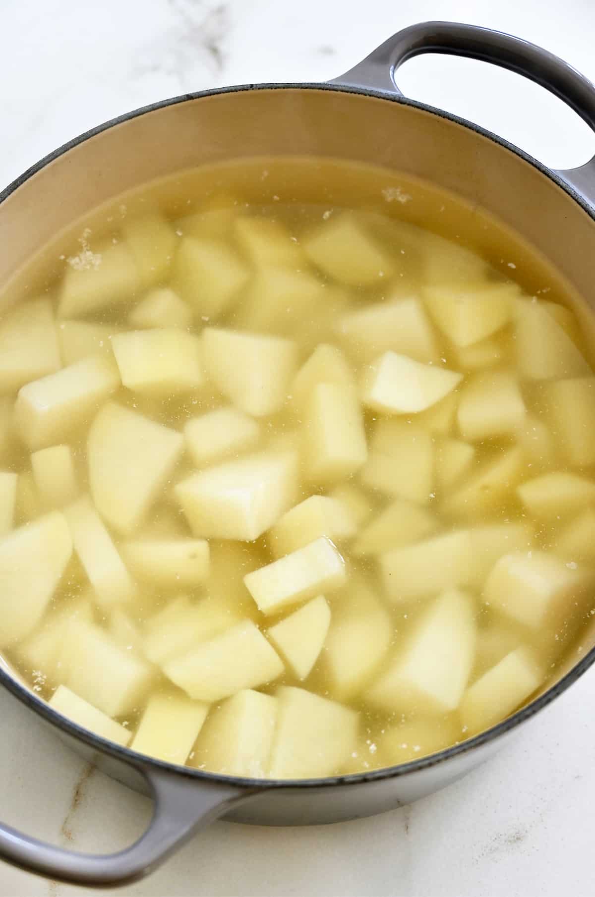 Boiling potatoes in a large stockpot.