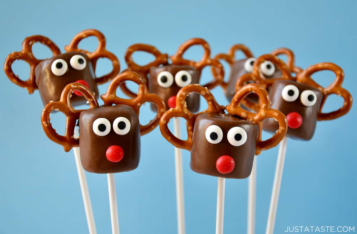 Chocolate reindeer marshmallow pops with pretzel "antlers," candy eyes and red noses.
