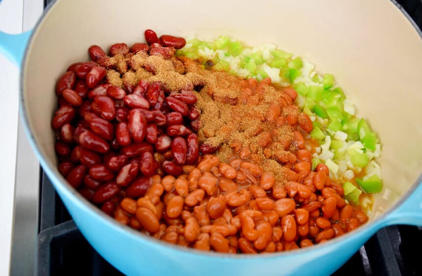 Beans, diced onion and spices in a large blue stockpot