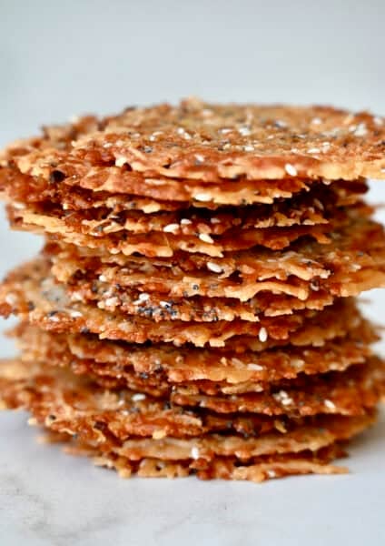 A tall stack of baked Parmesan cheese crisps with everything bagel seasoning.