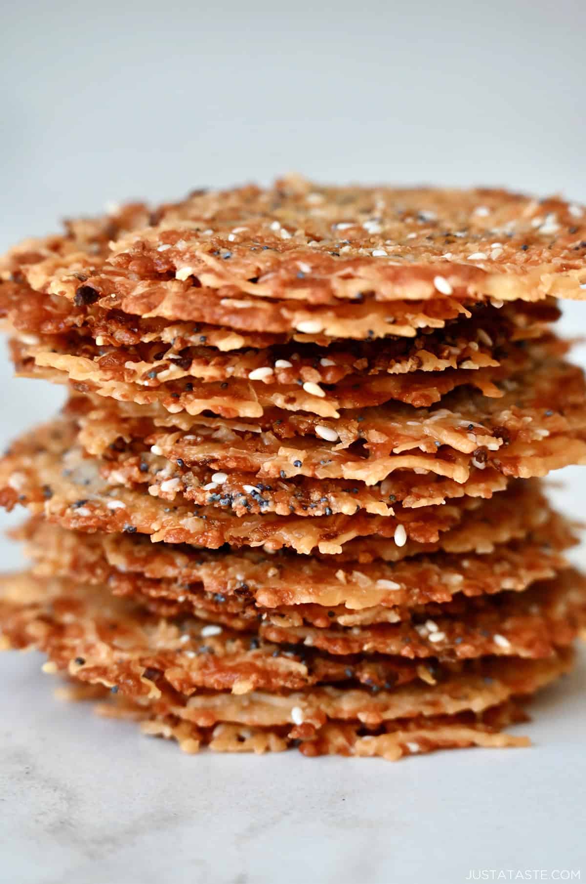 A tall stack of baked Parmesan cheese crisps with everything bagel seasoning.