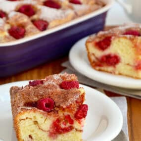 Raspberry sour cream coffee cake on a small white plate.