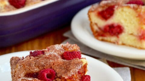Raspberry sour cream coffee cake on a small white plate.