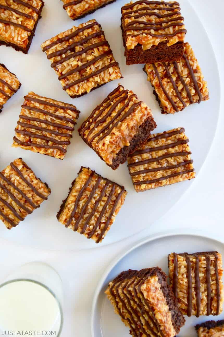 A top-down view of Samoas Coconut Caramel Brownies on a white serving plate.