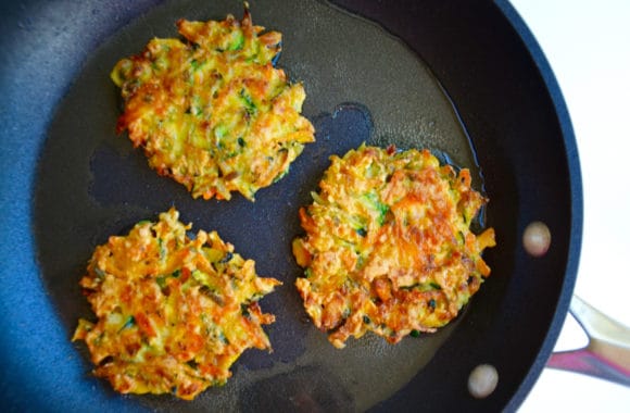 Large sauté pan with three veggie fritters