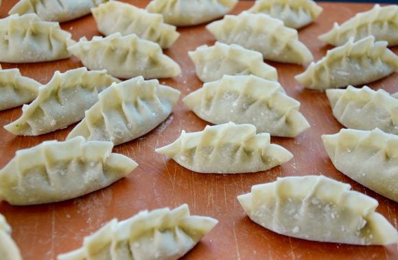 Pleated potstickers ready for frying