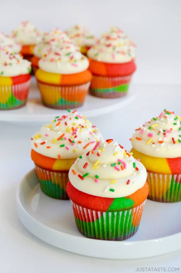 Rainbow Cupcakes with Buttercream Frosting and sprinkles on white plate