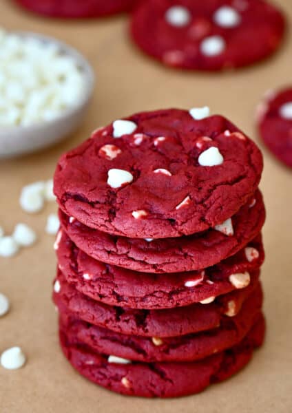 A stack of red velvet cookies studded with white chocolate chips.