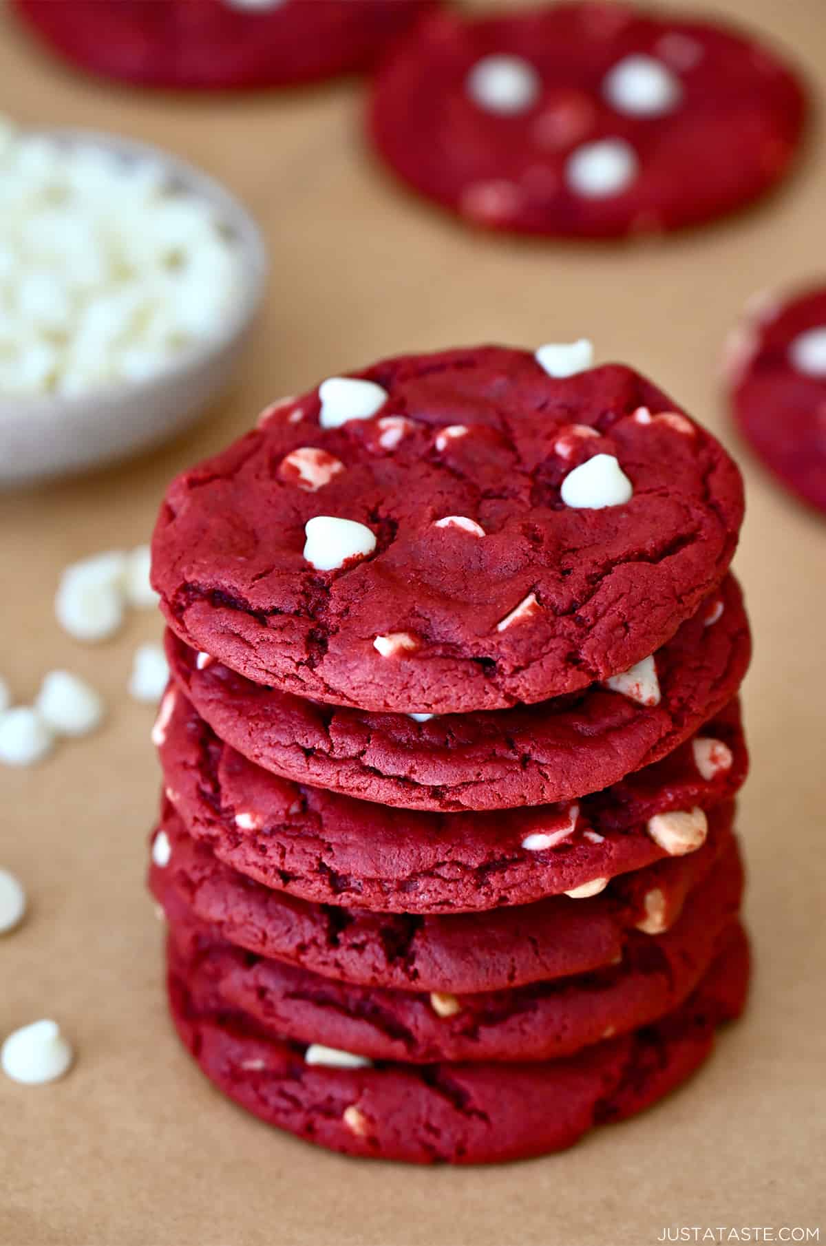 A stack of red velvet cookies studded with white chocolate chips.