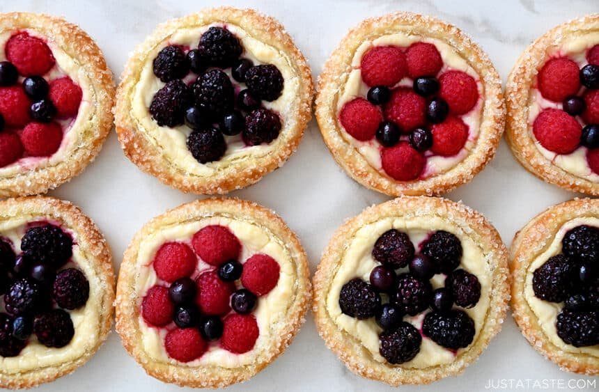 A top-down view of easy cream cheese pastries topped with fresh raspberries, blueberries and blackberries