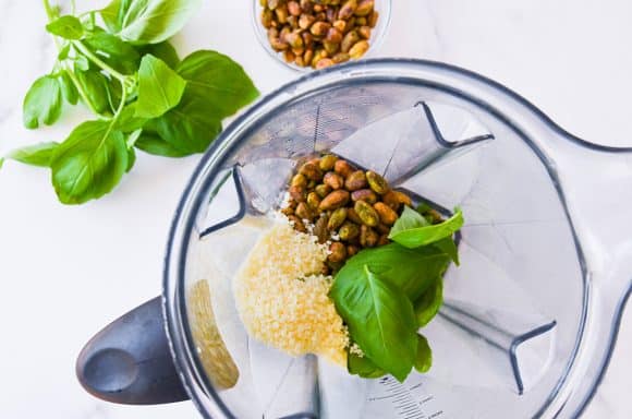 pistachios, basil and cheese in a blender jug