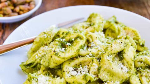 Bowls of tortellini pasta tossed with pistachio pesto