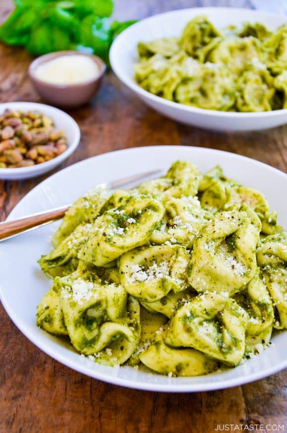 Bowls of tortellini pasta tossed with pistachio pesto