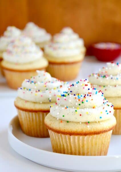 Very vanilla cupcakes with piped vanilla bean buttercream frosting.