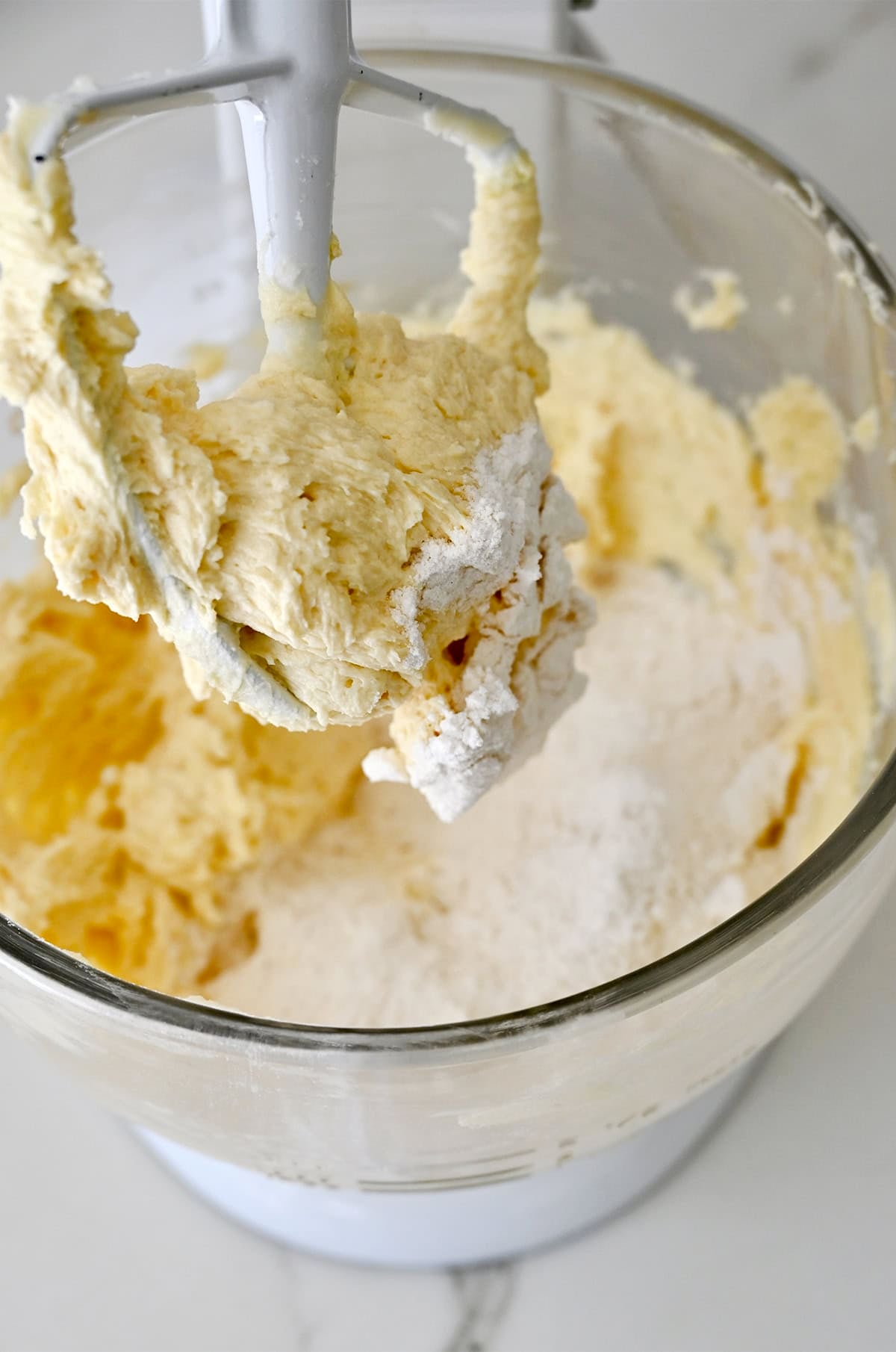 Adding dry ingredients to make cupcake batter.