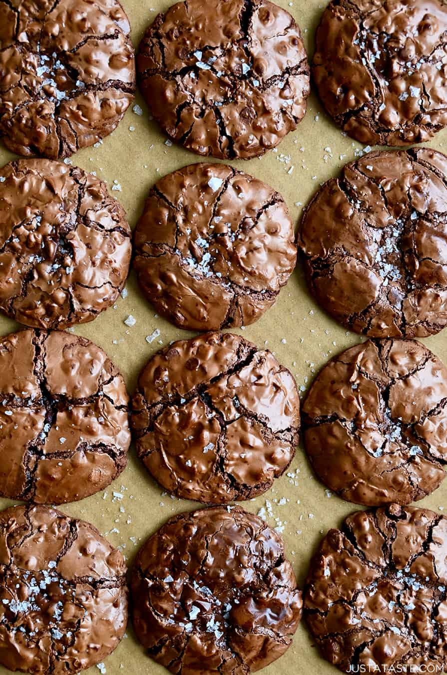 A top-down view of Flourless Chocolate Cookies dusted with large-flake sea salt