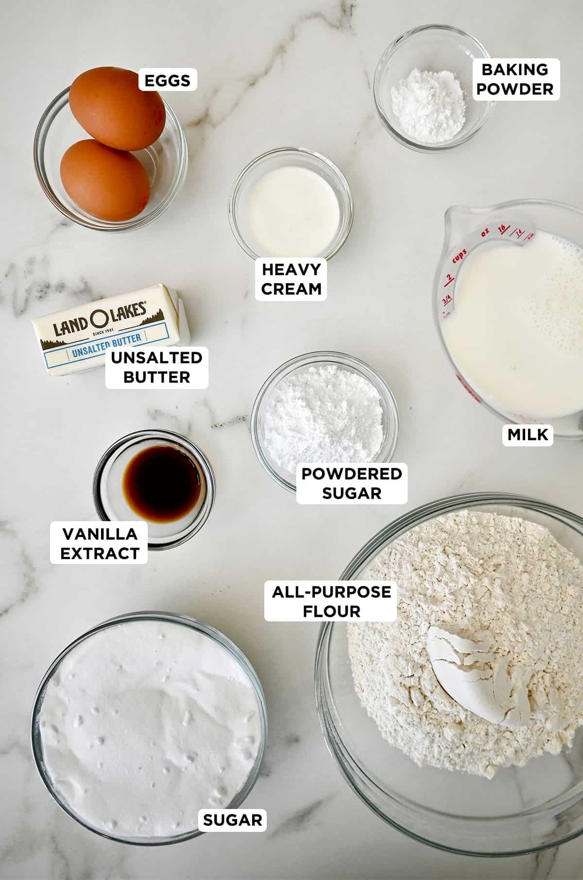 Vanilla cupcake ingredients in various sizes of prep bowls.